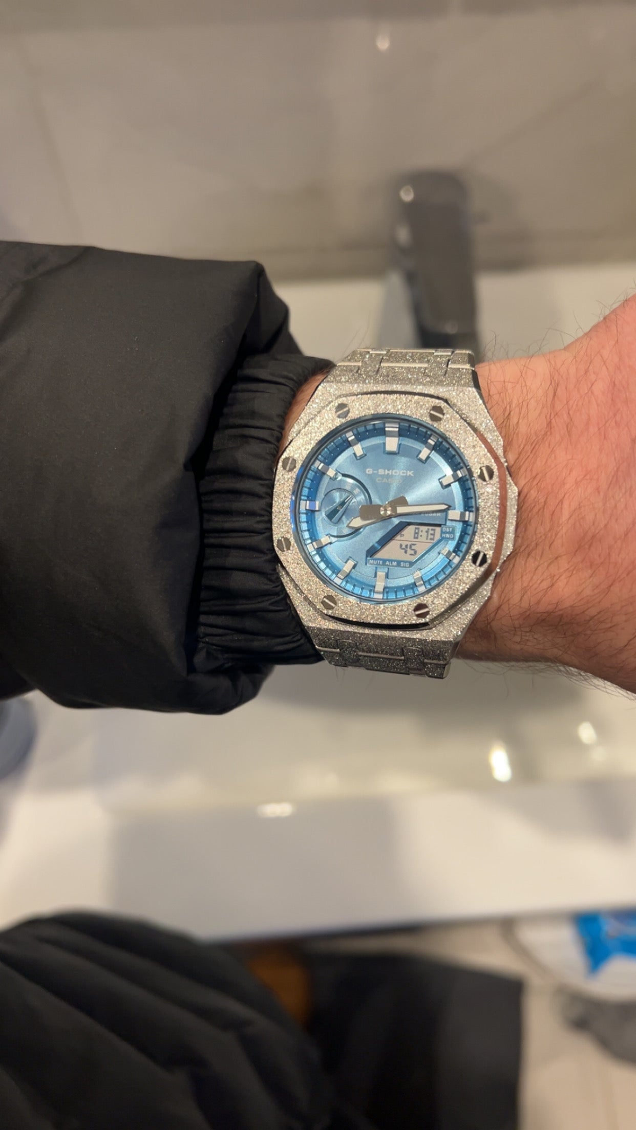 Frosted blue stainless steel CasiOak mod on wrist