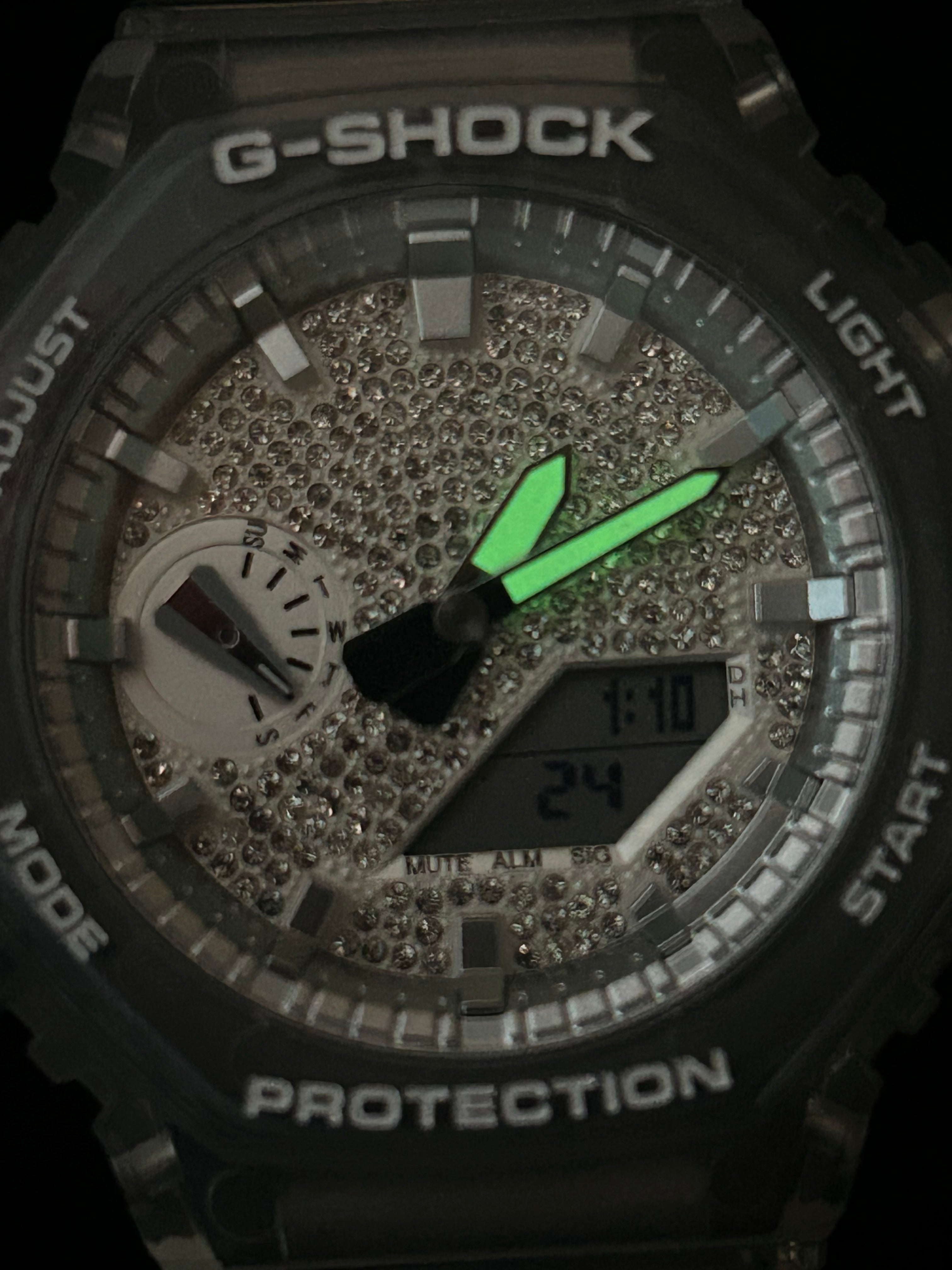 G-Shock watch with green second hand on a dark background