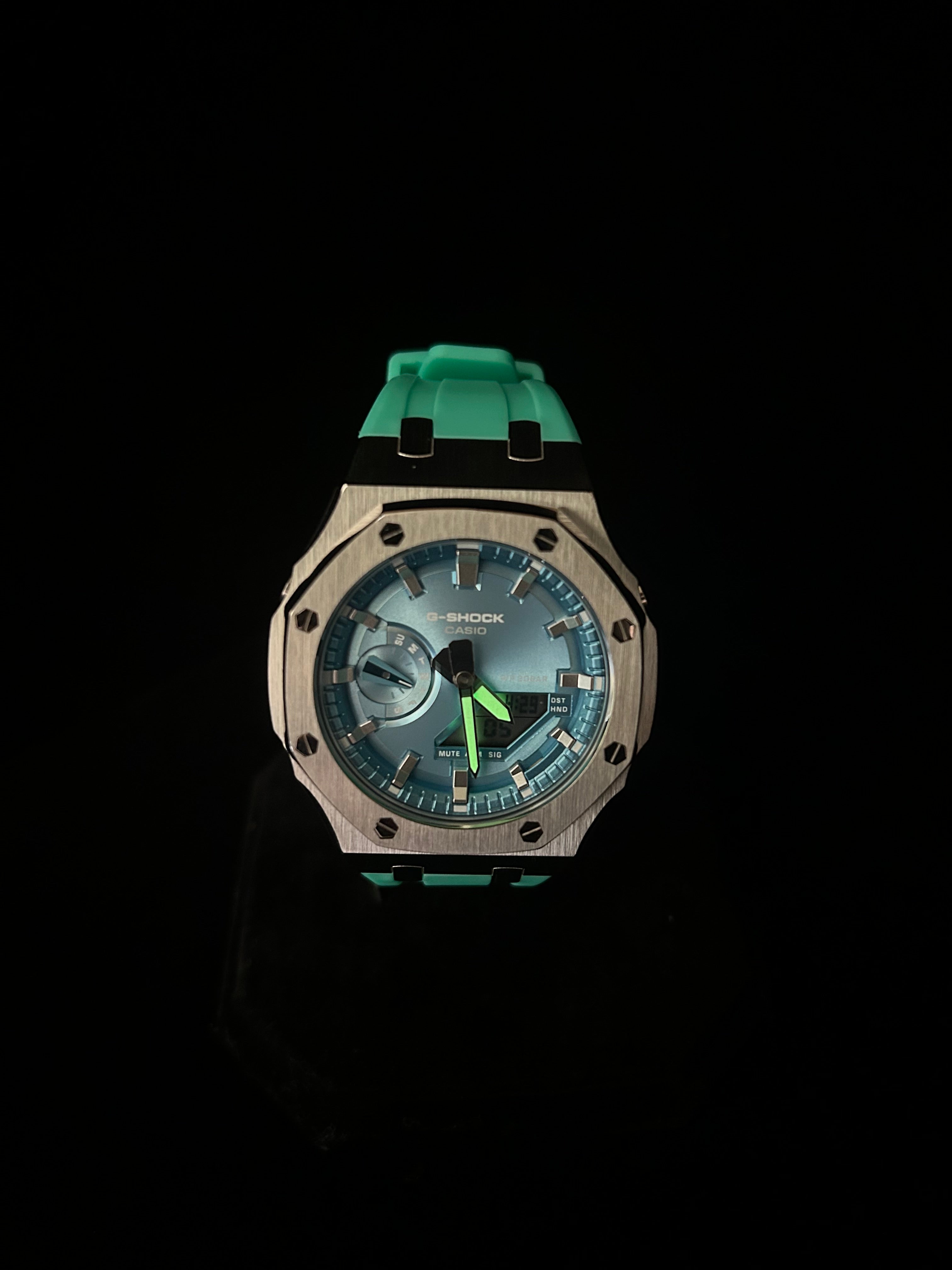 Wristwatch with a green strap on a black background