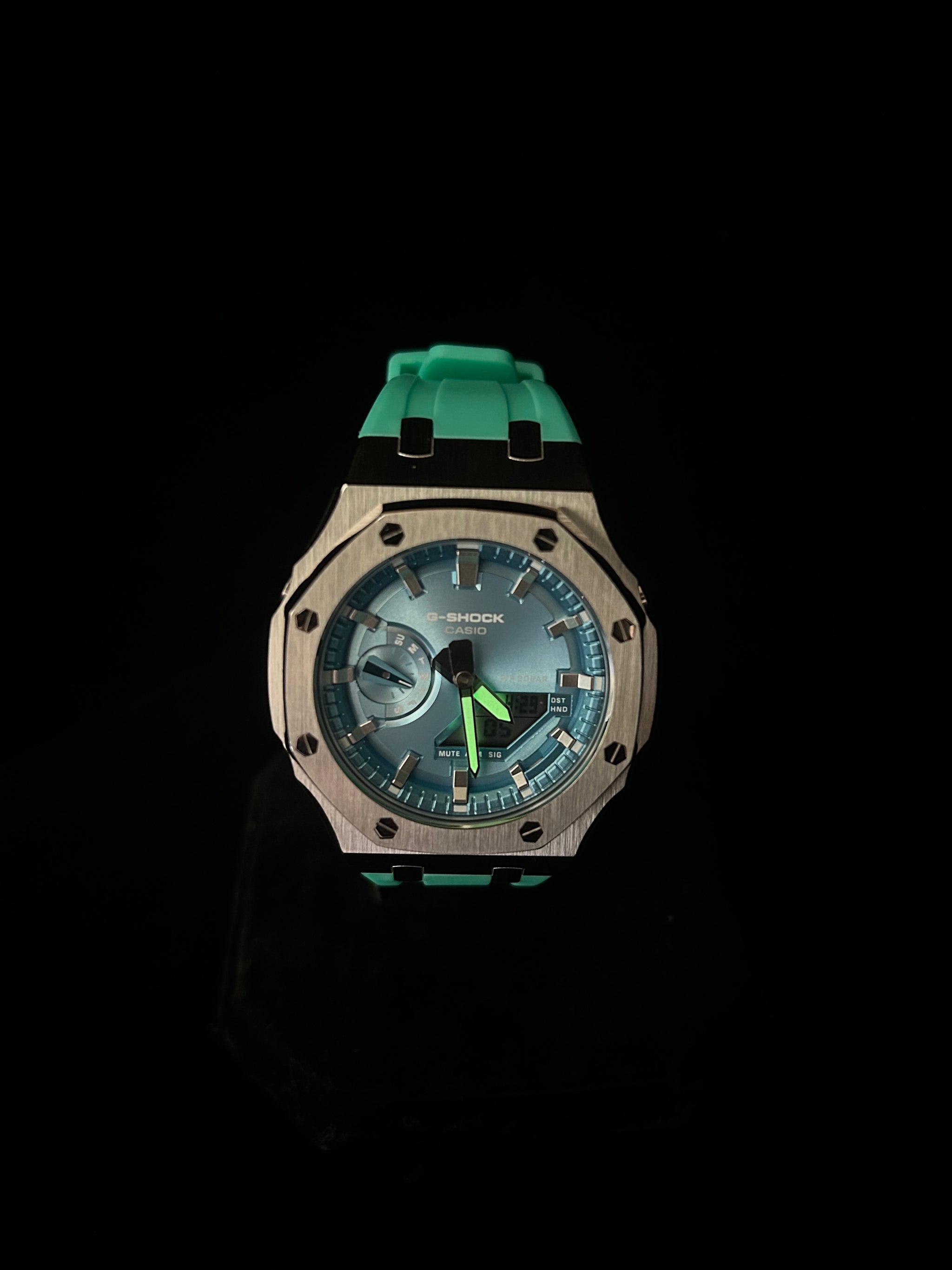Wristwatch with a green strap on a black background