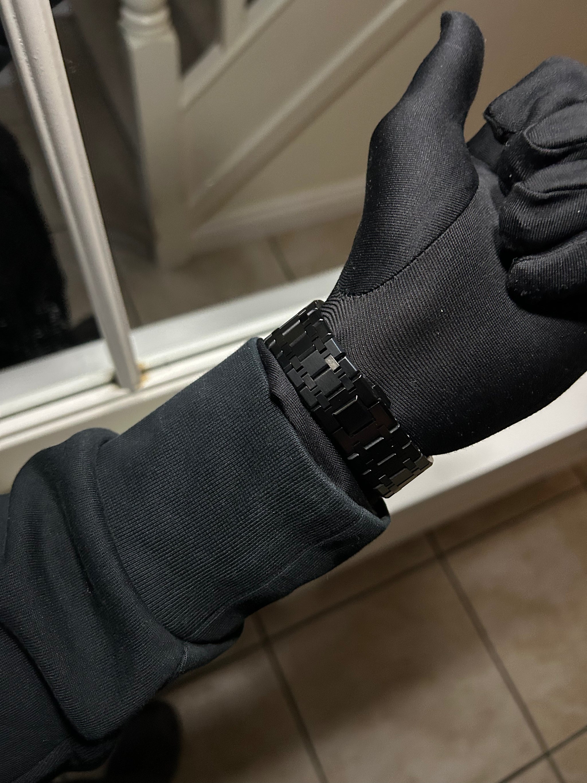 Black glove with a buckle on a neutral background