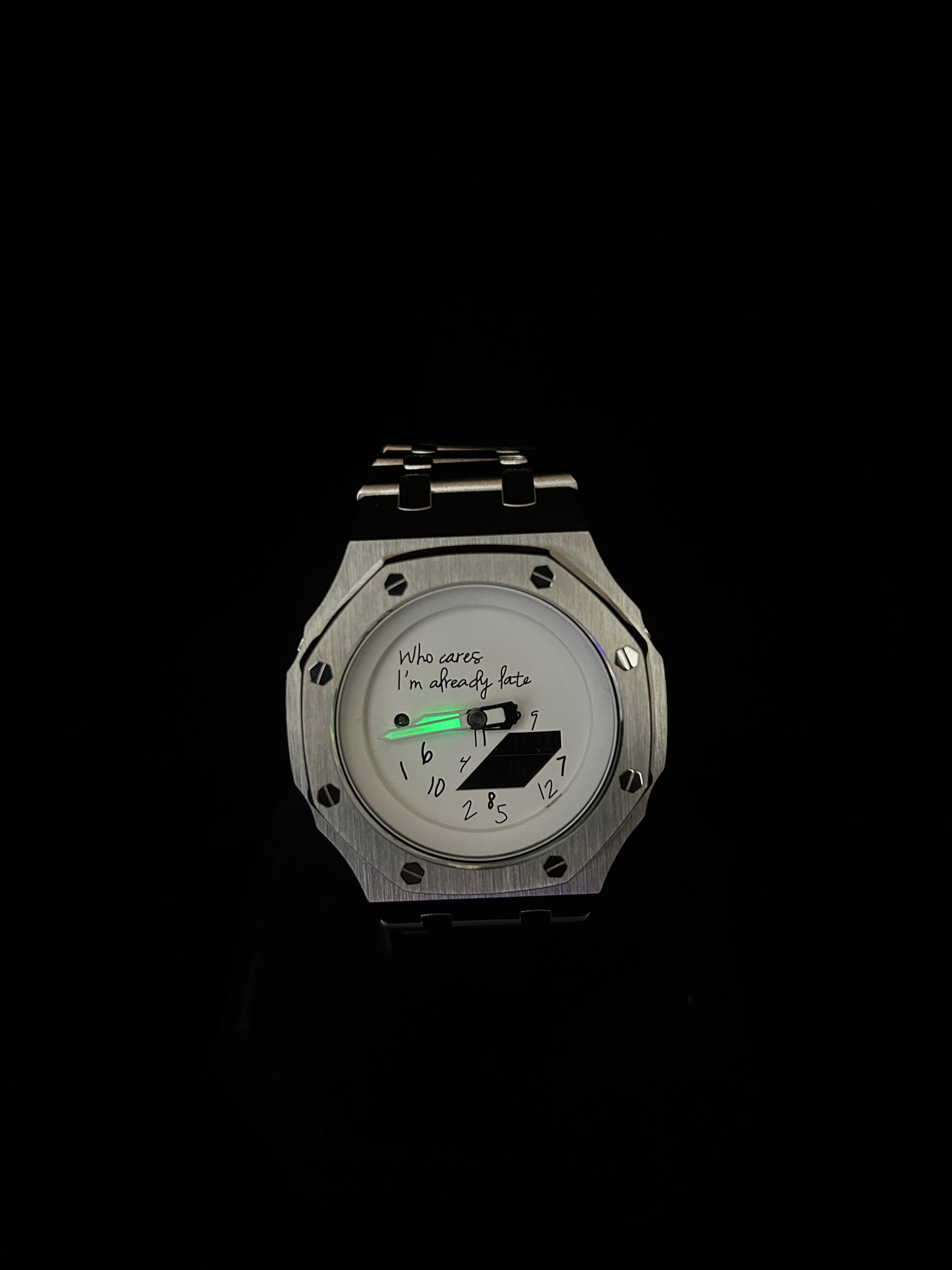 Silver watch with a digital display on a black background