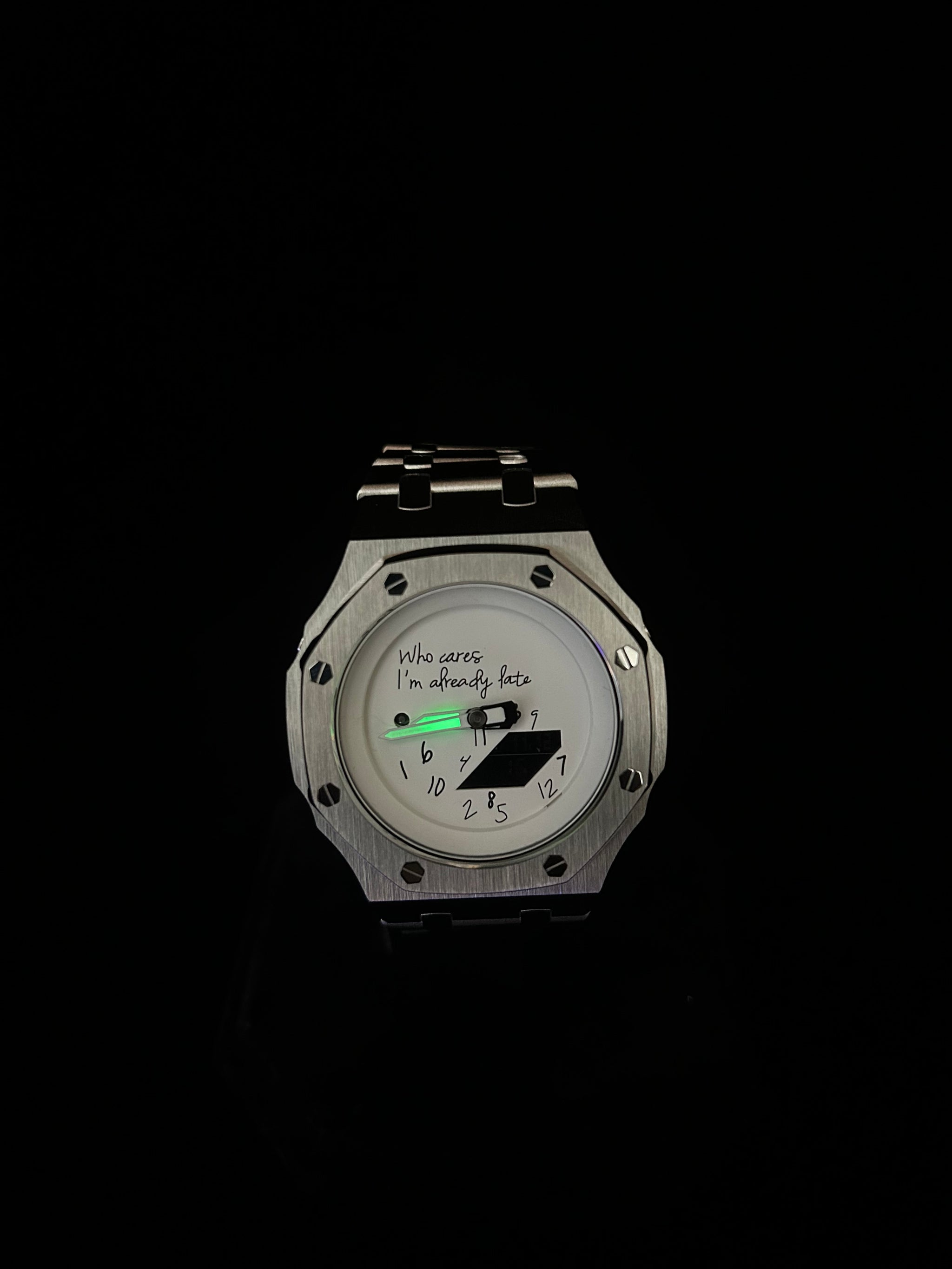Silver watch with a digital display on a black background