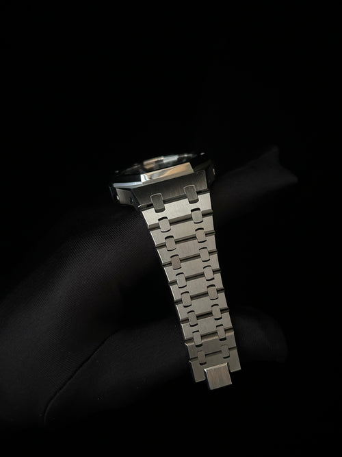 Metallic watch strap on a black background