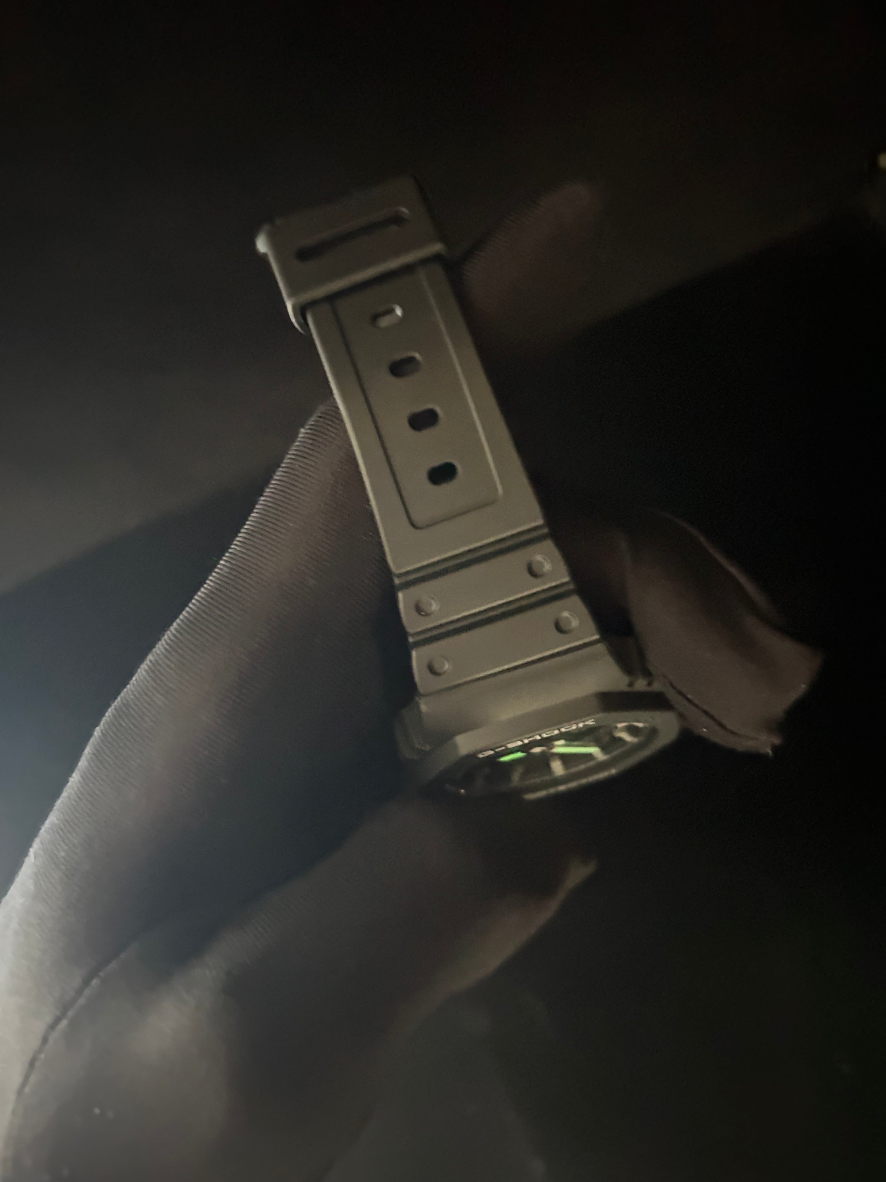 Close-up of a watch bracelet with a dark background
